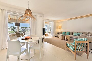 A living room with a table and chairs and a couch