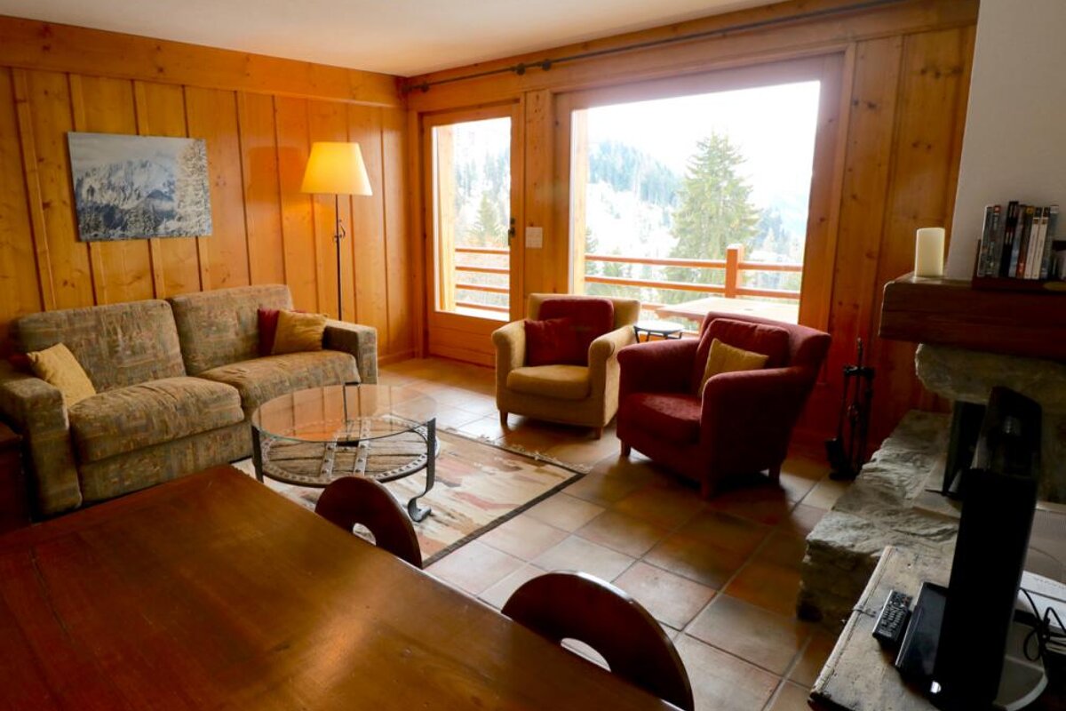 A living room with a couch and two chairs