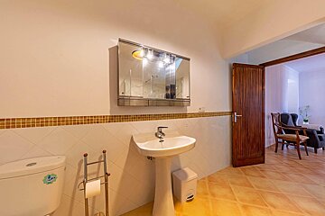 A bathroom with a toilet a sink and a mirror