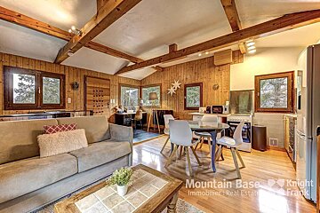 A living room with a couch and a table that says mountain base on it