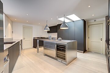 A kitchen with stainless steel cabinets and a wine cooler