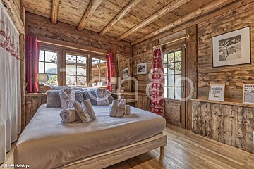 A bedroom with a bed and a sign that says