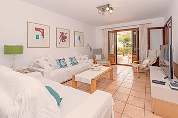 A living room with a couch a table and a television