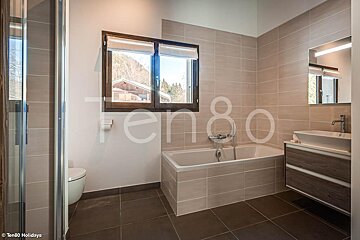 A bathroom with the word ten80 on the wall