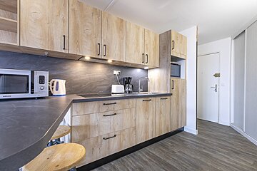 A kitchen with wooden cabinets and a samsung microwave