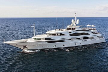 A large white yacht is floating in the ocean