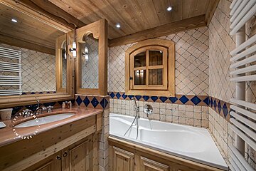 A bathroom with a bathtub and a sink with a sign that says ' provence ' on it