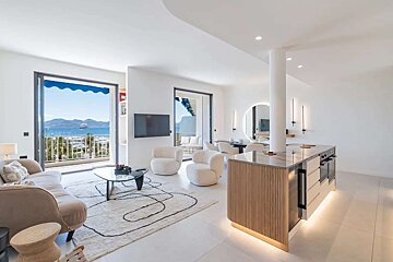A living room with a couch and chairs and a flat screen tv
