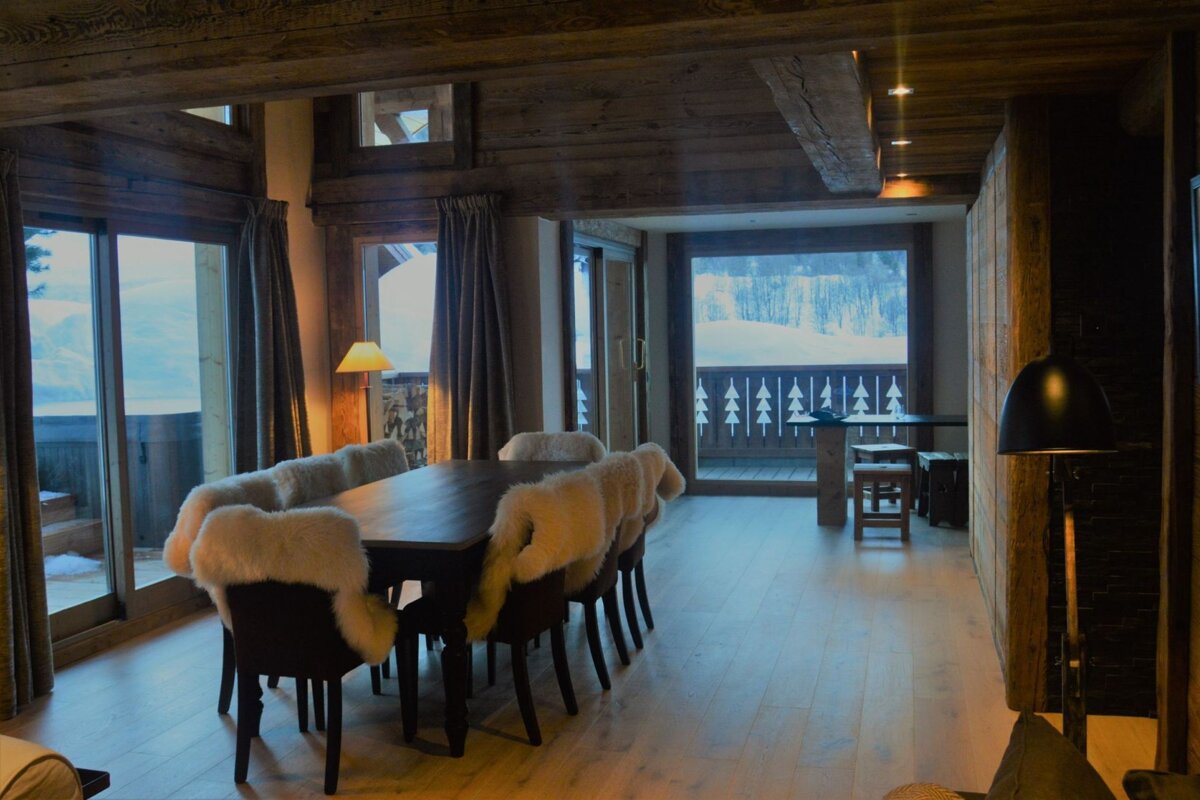 A dining room with a large table and chairs