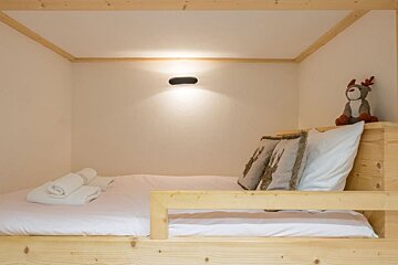 A bunk bed with a stuffed reindeer on it