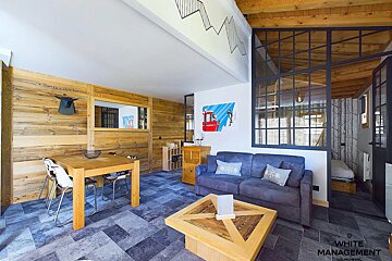 A living room with a couch and a painting on the wall