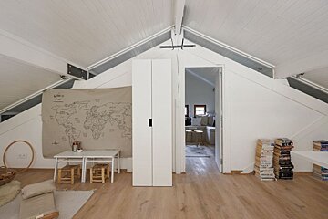 A map of the world hangs on the wall above a table