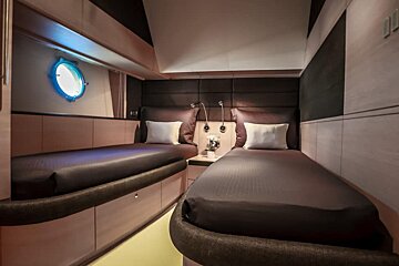 A bedroom with two beds and a window