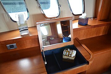 A box of tissues sits on a counter next to a mirror