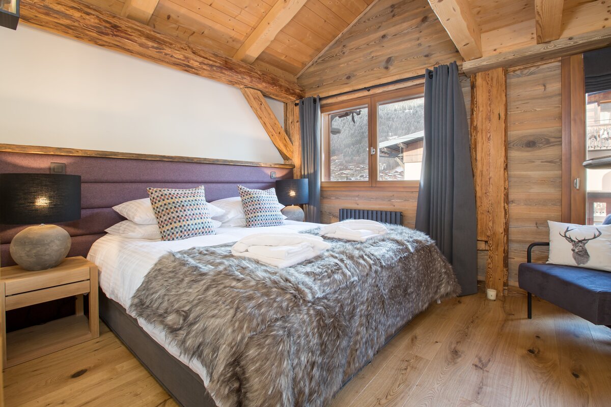 A bedroom with a large bed and a couch