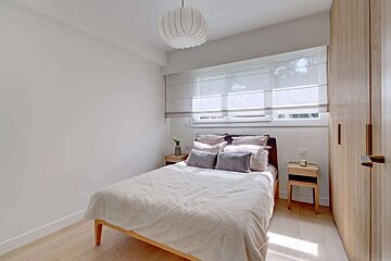 A small bedroom with a bed and two nightstands