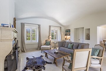 A living room with a couch and chairs and a fireplace