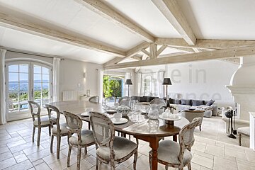 A dining room with a table and chairs and a sign that says made in france