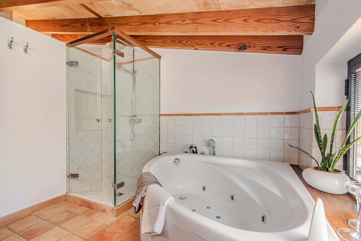 A bathroom with a jacuzzi tub and a walk in shower