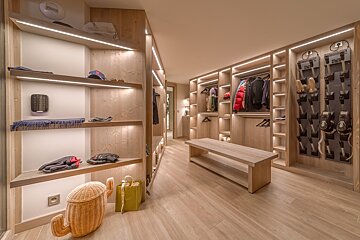 A walk in closet with a cactus shaped basket on the floor