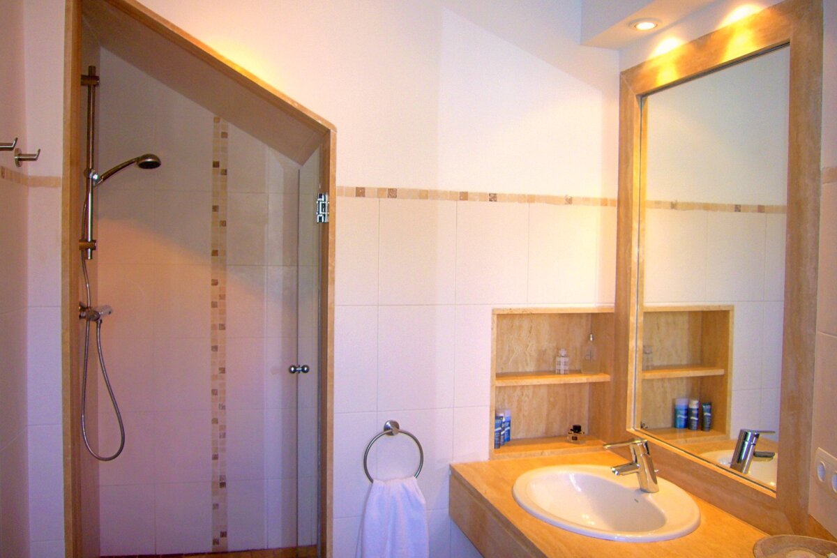 A bathroom with a sink and a walk in shower