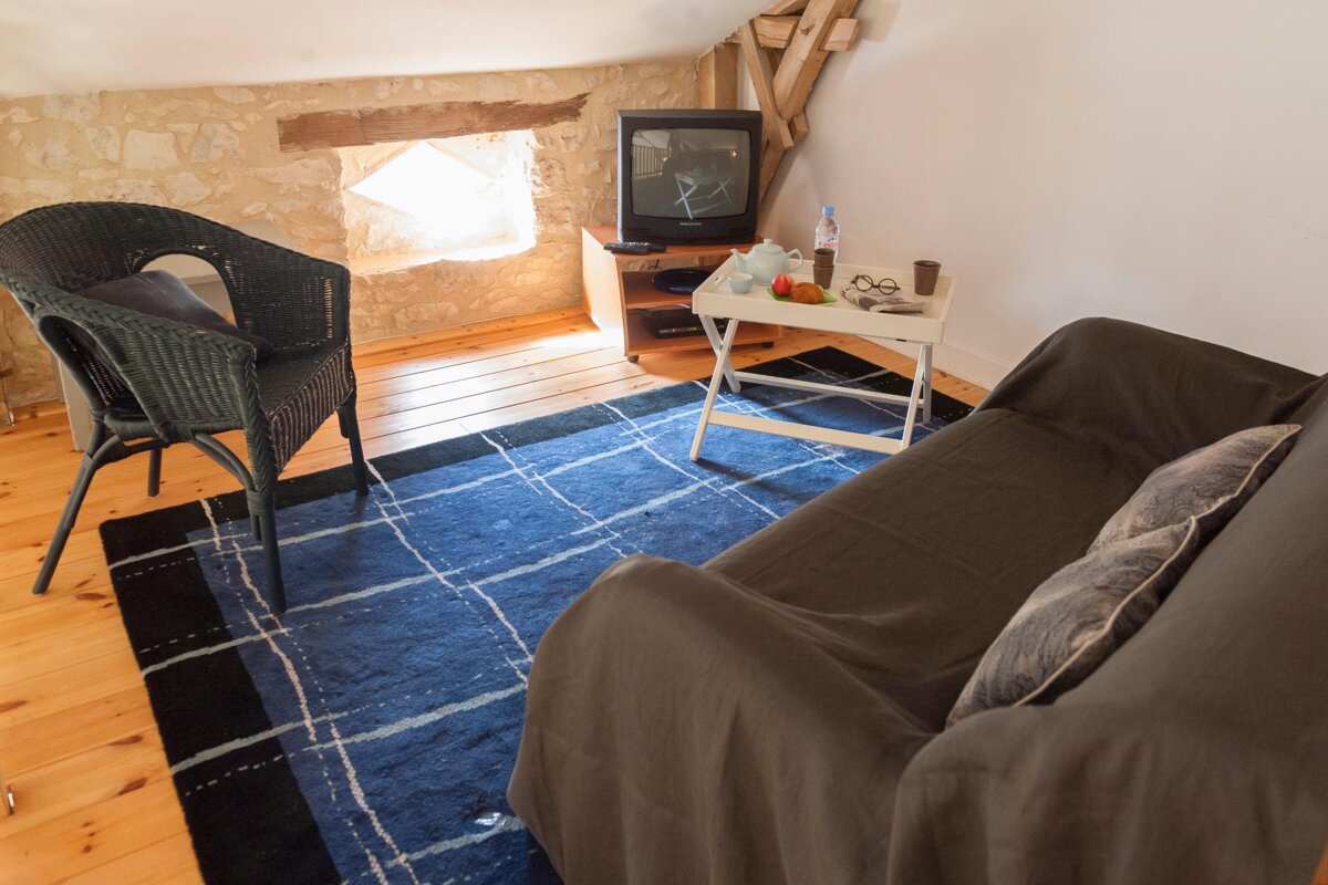 A living room with a couch a chair and a television