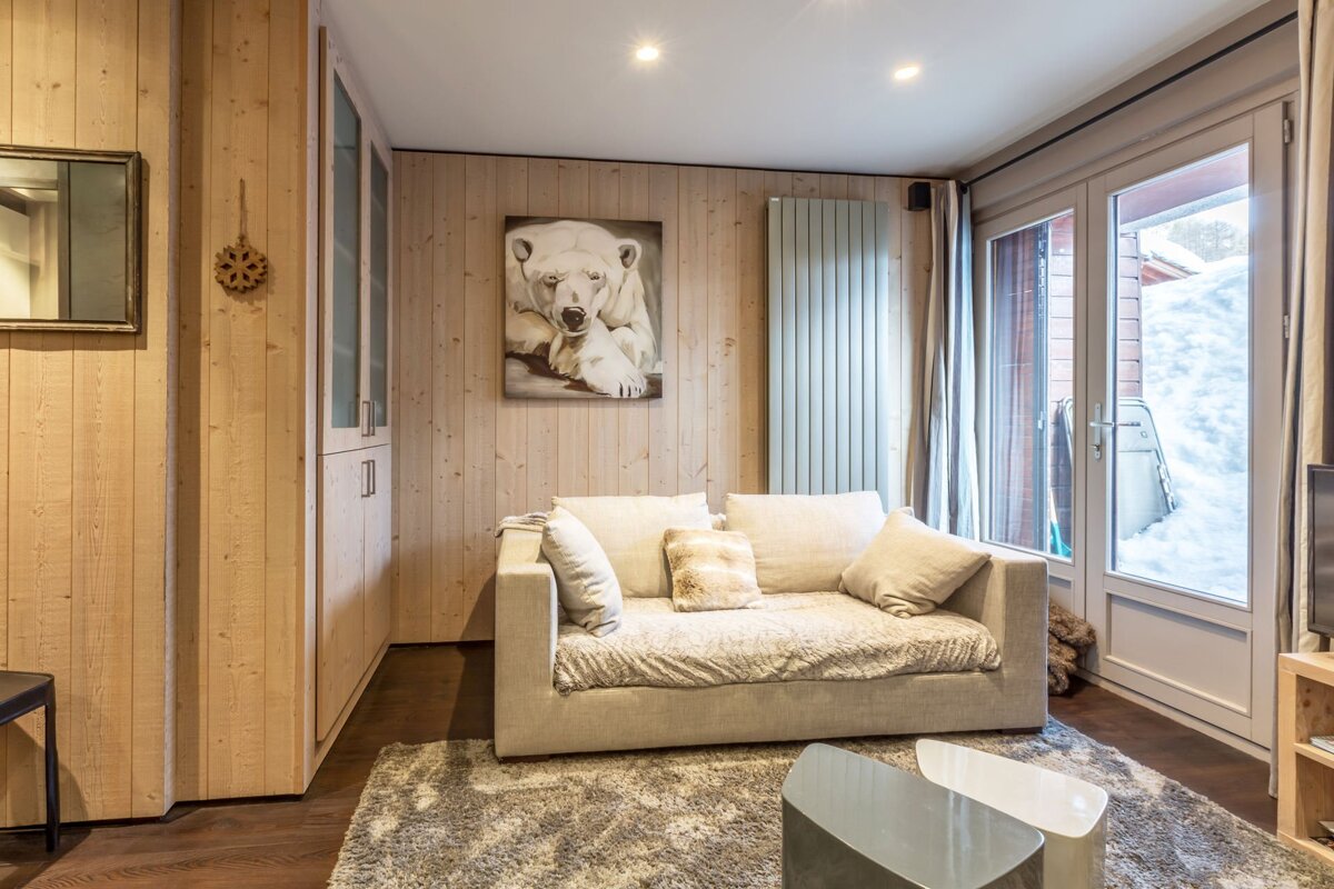 A small kitchen with a flat screen tv on the wall