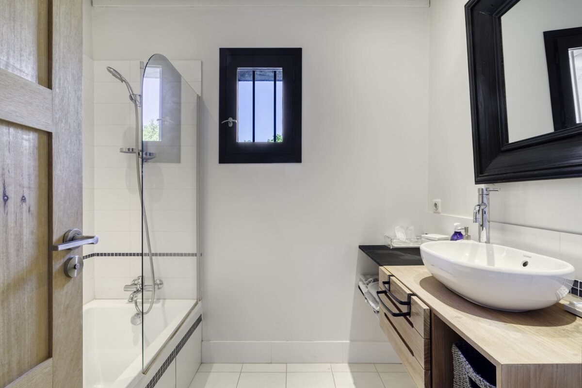 A bathroom with a sink and a window