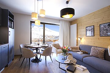 A living room with a couch a table and chairs