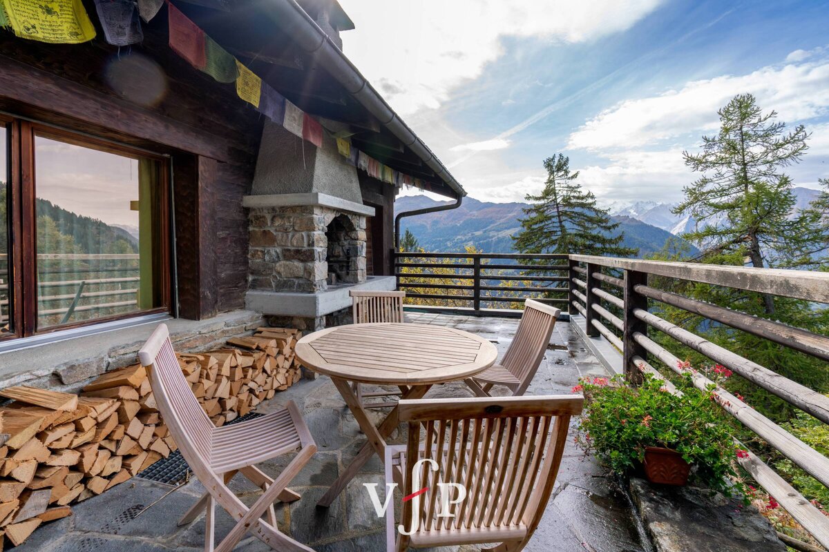 A table and chairs on a balcony with vip written on the bottom
