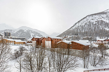 A bedroom with a bed and a pillow that says val d' isere