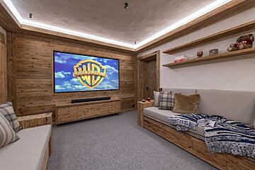A room with a projector screen that says ' warner bros ' on it