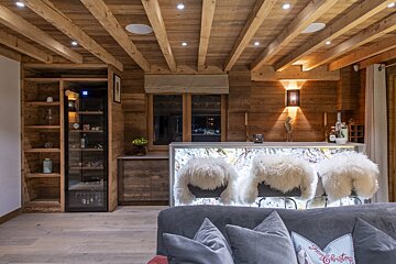 A living room with a christmas sign on the couch