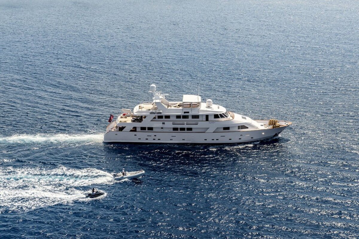 A large white yacht is in the middle of the ocean