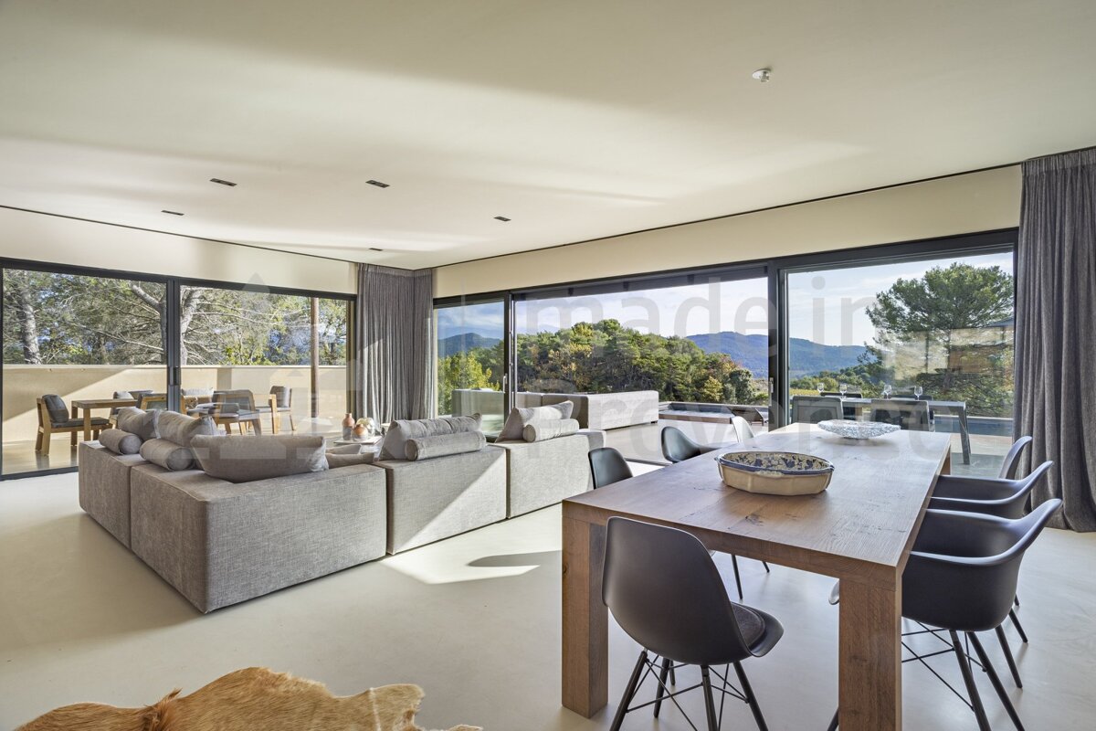 A living room with a dining room table and chairs
