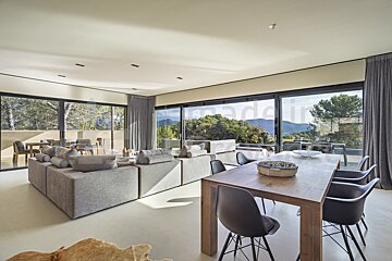 A living room with a dining room table and chairs