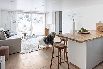 A wooden table with artichokes on it in a living room