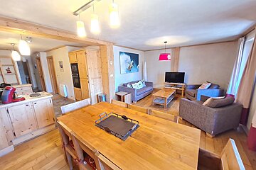 A living room with a table and chairs and a couch