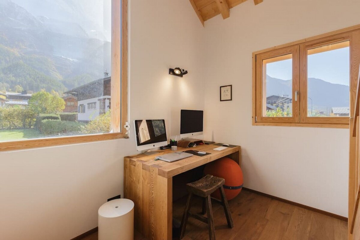 A wooden desk with an apple computer on it