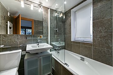 A bathroom with a toilet sink and bathtub
