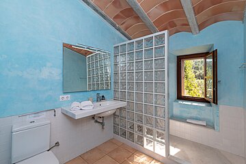 A bathroom with blue walls and a window