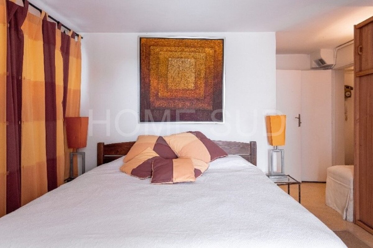 A bedroom with a bed and a painting that says home