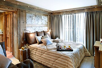 A bedroom with a bed and a tray on it