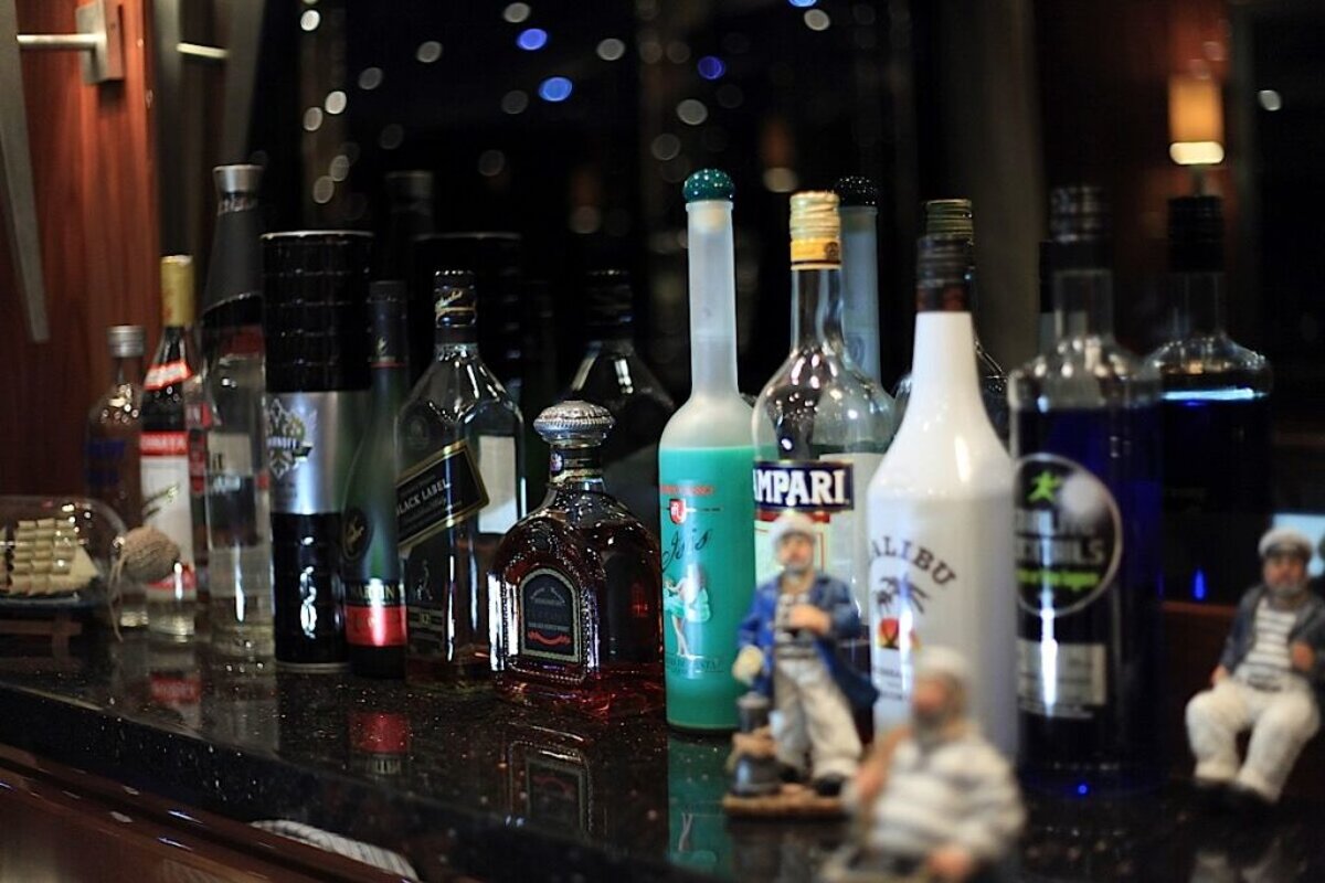 Several bottles of liquor including malibu and campari