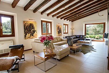 A living room with a painting of a bull on the wall