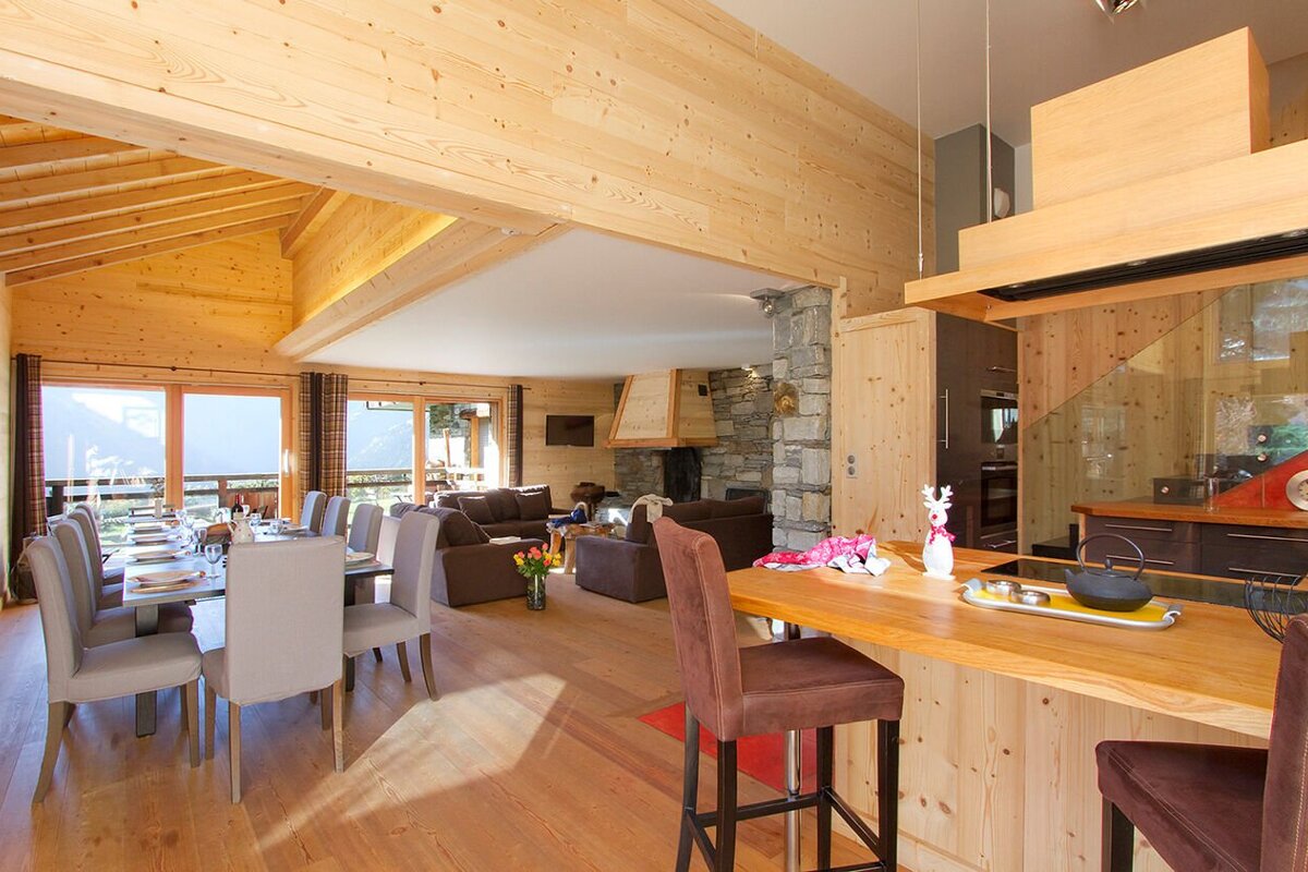 A living room with a dining table and chairs