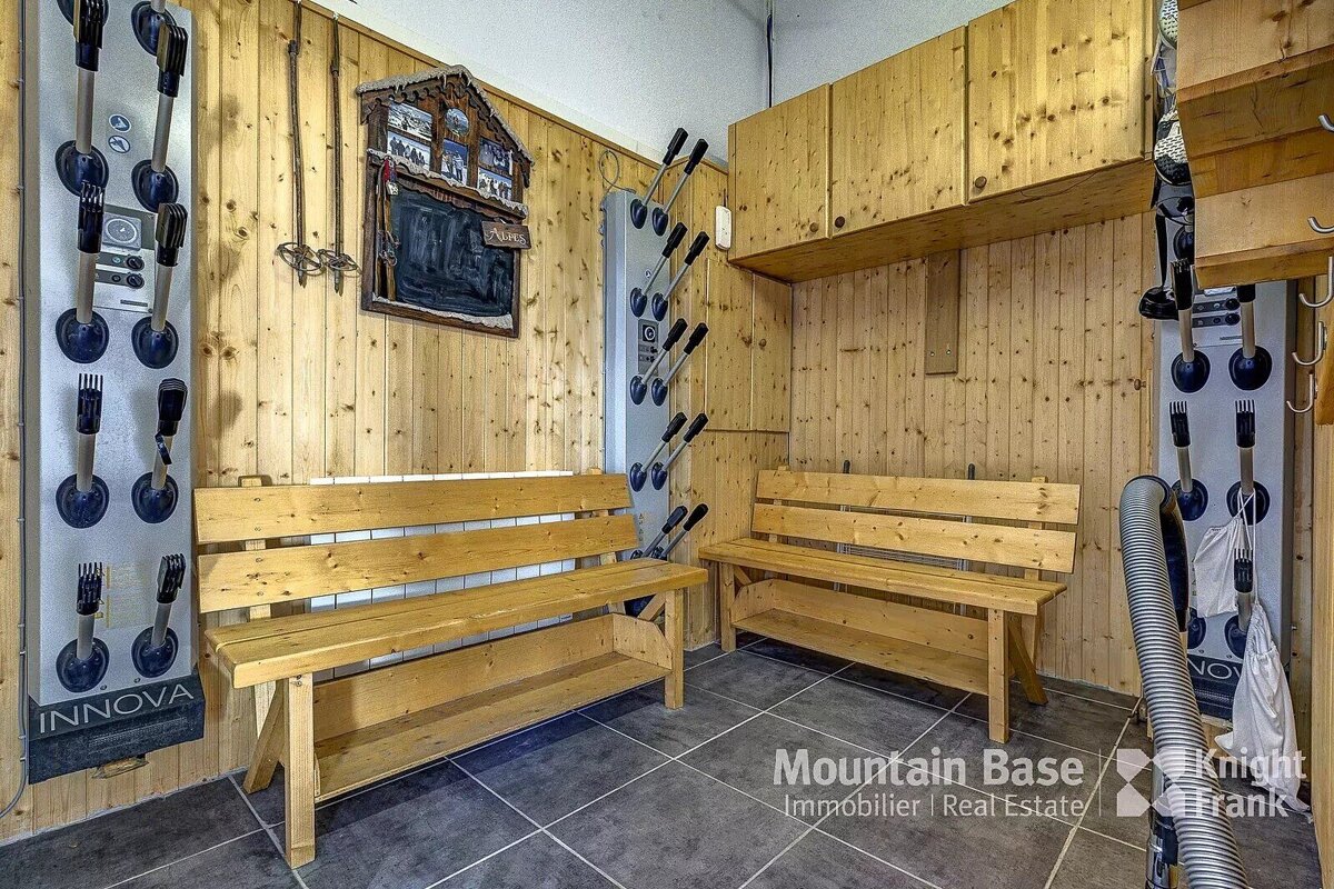 A room with a bench and a sign that says mountain base