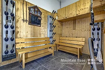 A room with a bench and a sign that says mountain base