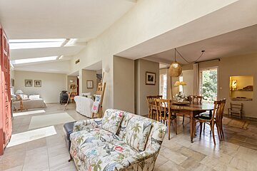A living room with a couch and a table and chairs