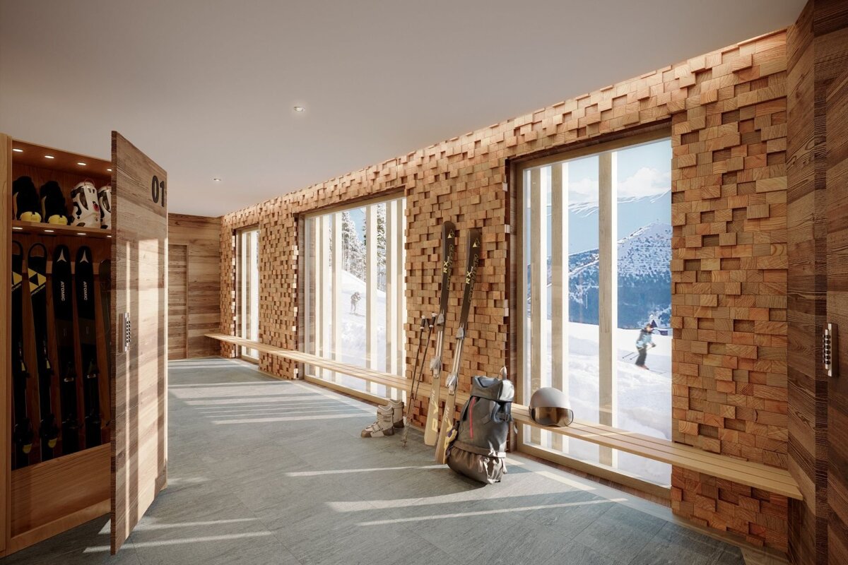 Modern ski locker room with textured wood-block walls, ski equipment, and large windows overlooking snowy slopes.